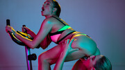 Lesbians play erotic during a gym session