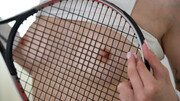 Tennis lover flashes her muff through the racket